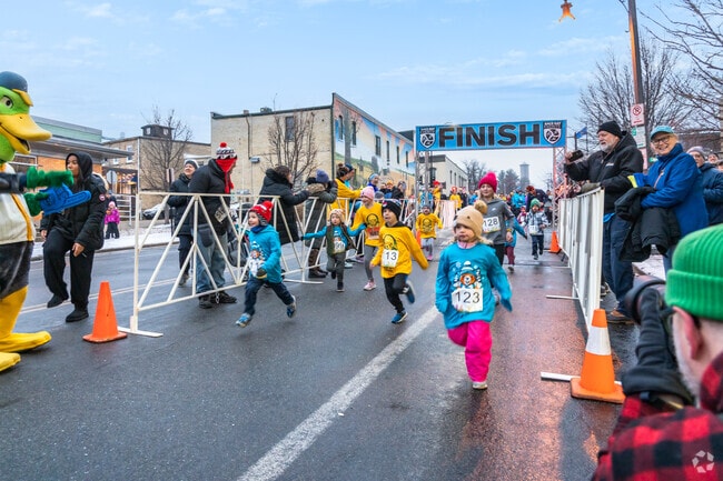 Children race down the hill at the start of the kids dash during the Hibernation Hustle 5K.