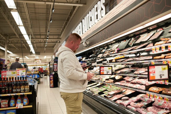 A customer shops in the meat section at Tops Market in Hamlin.