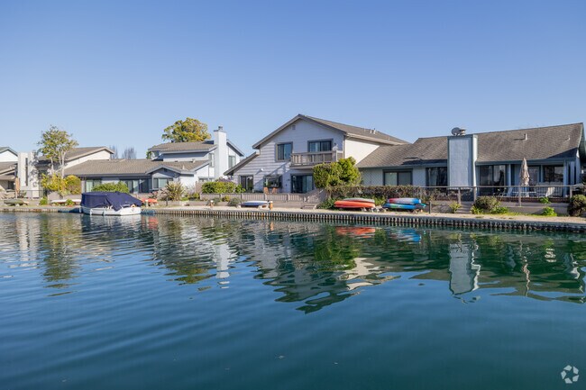 Kayaks and boats line the docks of The Islands’ contemporary waterfront homes in Foster City.