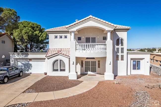 This 2-story Mediterranean style home has a front balcony in High Range.