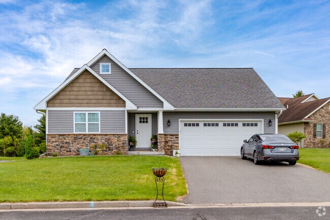 Ranch-style home blends craftsman details with modern curb appeal and a neatly maintained yard in Weston.