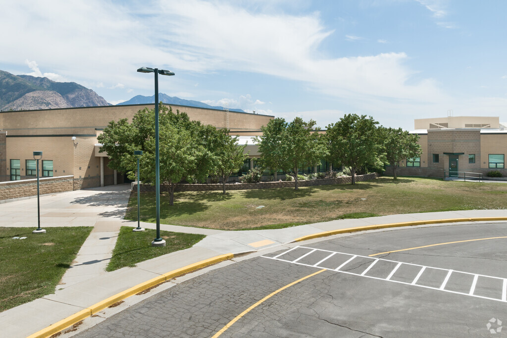 Majestic Elementary School is a beige building with a row of trees planted at the entrance.