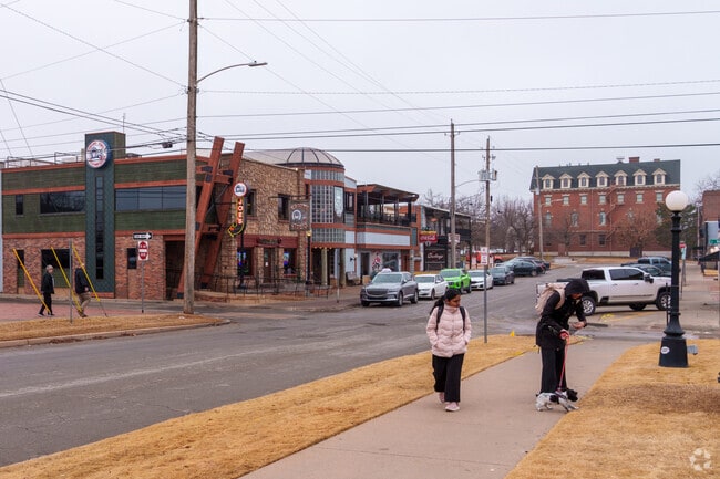 Students walk past the iconic Eskimo Joe’s in Stillwater, a favorite gathering spot for food and fun.