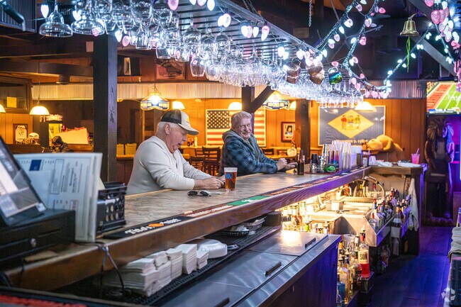 A couple of friends trade stories over a beer at Park Place Lounge and Restaurant.