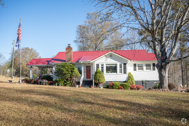 A single-story home with beautiful landscaping and a large front yard in Slater-Marietta.