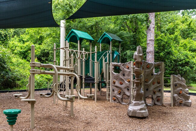 Children enjoy playing at the playground in Cofrin Nature Park.