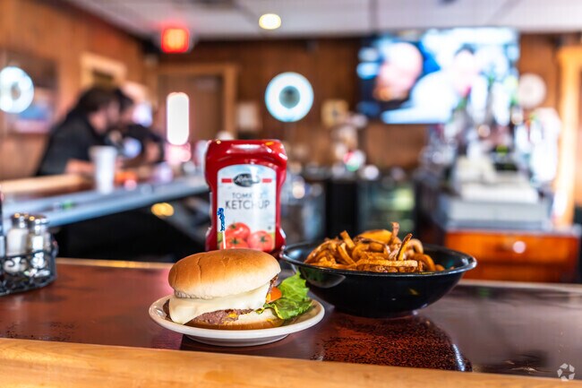 A buffalo burger with a side of curly fries is a common dish at Hide-A-Way in East Fairmount.