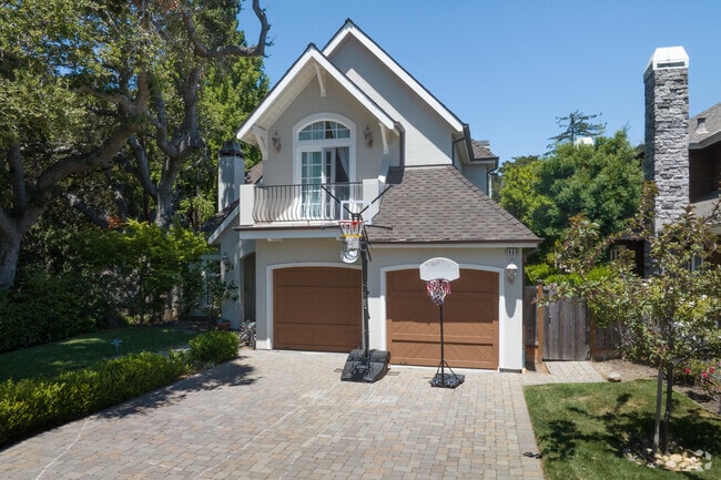 Beautiful custom driveways and mature trees surround this custom home in Ray Park.