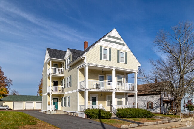Multifamily home with a full-facade porch in East Woonsocket, RI.