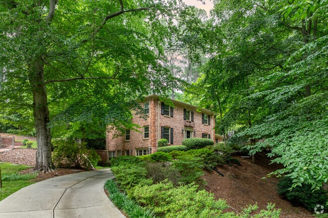 Surrounded by lush greenery, this brick colonial-style home offers privacy and character in Sagamore Hills.