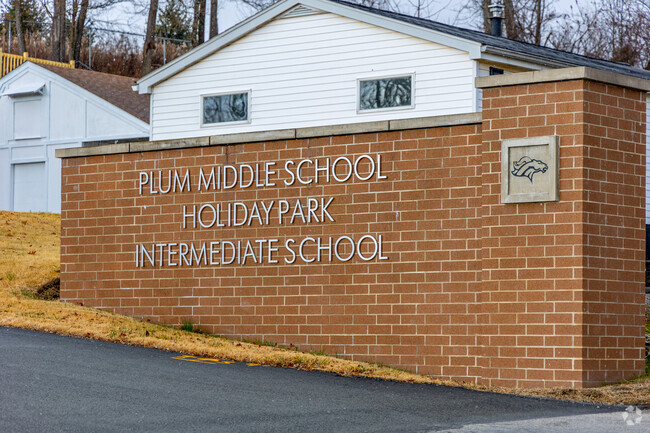 Plum Middle School is marked with a large brick monument located at the entrance.