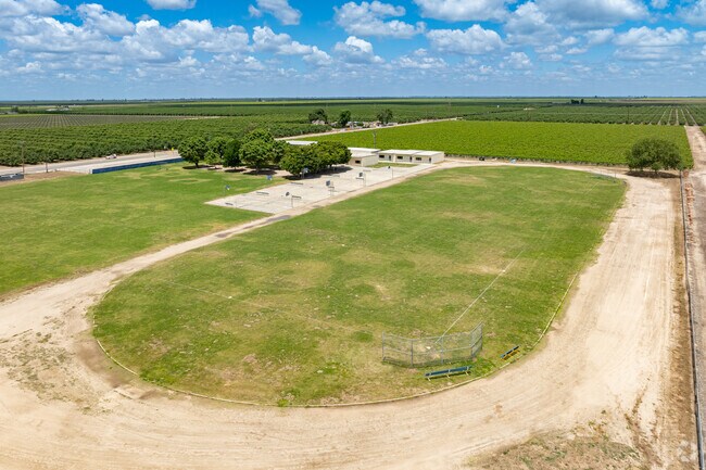 A large dirt track serves as a baseball field for students at Columbine Elementary School.