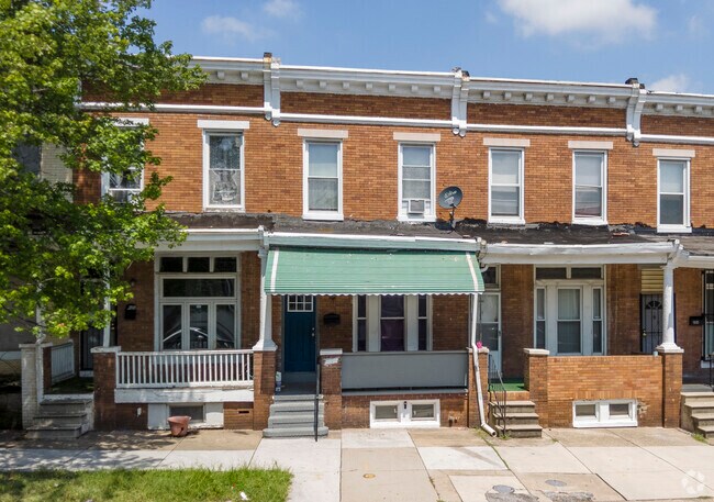Two-story rowhomes in South Clifton Park have bright colorful awnings.