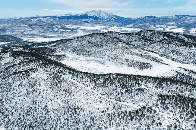 Sutey Ranch Trail Park transforms into a winter wonderland, offering visitors the chance to explore snow-covered trails for cross-country skiing and snowshoeing amidst breathtaking mountain views.