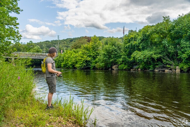 A fisherman casts their reel with hopes to catch salmon on the Shetucket River in Sprague.