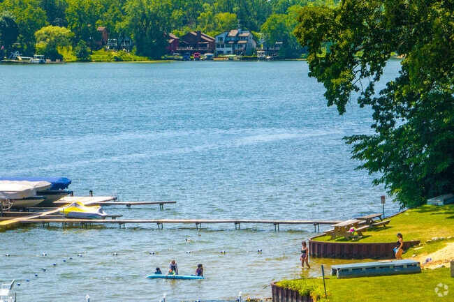 Locals go for a swim along the waters of Lake Diamond in West Shore Park.