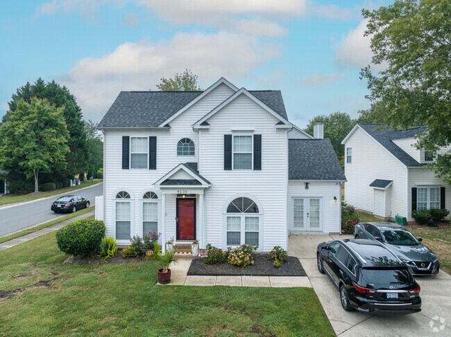 A red door stands out on this large Northlake home.