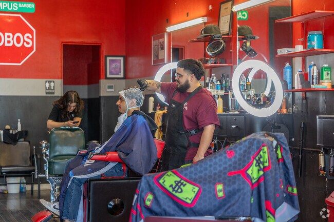A fresh fade in progress inside Lobos Barbershop in University Heights.