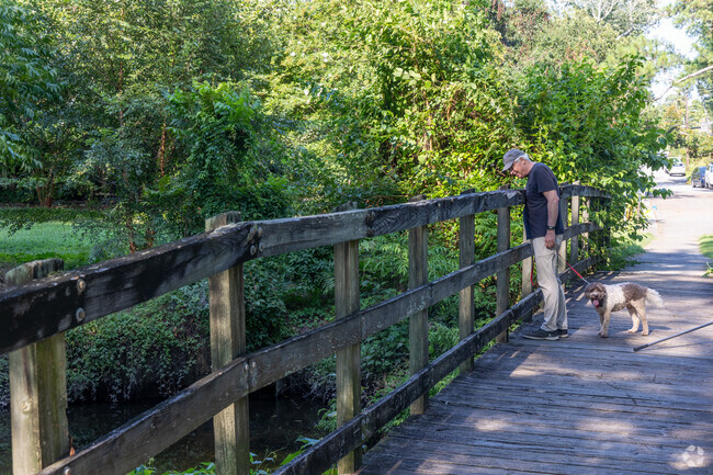 An Old wooden bridge connects Carolina Place and Brookwood in Wallace Park.