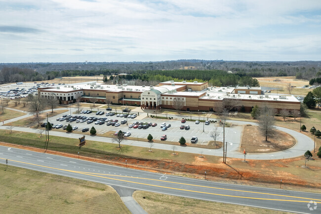 Greer High School has a large parking front in the front of the school.
