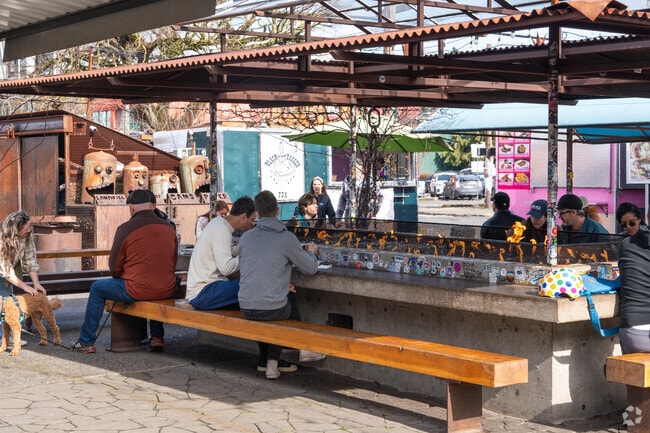 Cozy up next to the fire at Asylum food trucks, and enjoy the many food options.