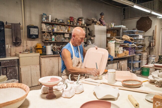 An artist prepares ceramics for the kiln in the Paseo Arts District of Jefferson Park.