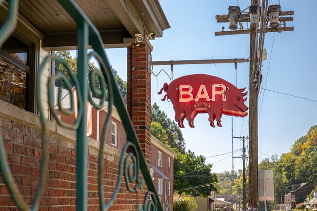 An 80 year old pig sign hangs outside of the Boar's Head Bar and Grill in Northview Heights.