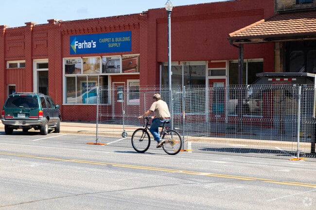 Morning riders pedal through Hillsboro’s downtown, past brick shops and vintage signs.