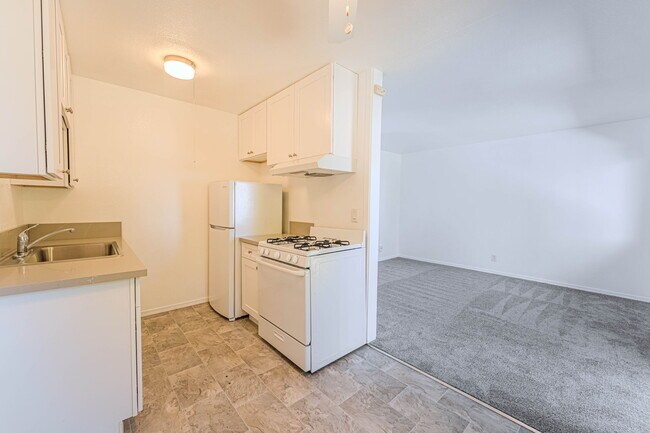 Kitchen and living room space partial view