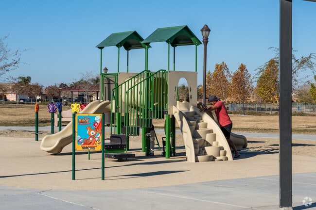 A child hides underneath the playground at Bridle Creek Park in Old River.