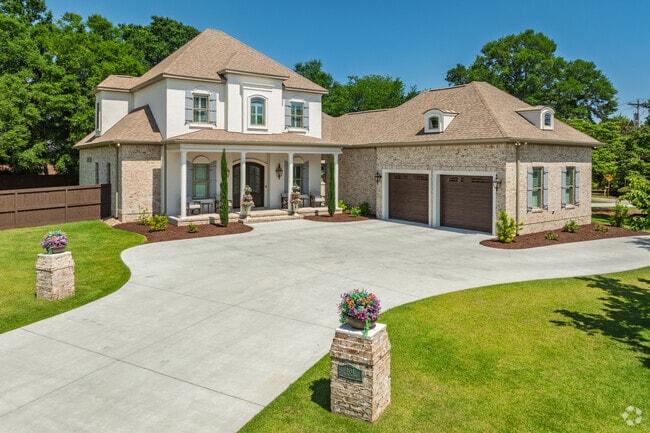 Elegant French Country-style residence in Grande Dunes features a spacious circular driveway.