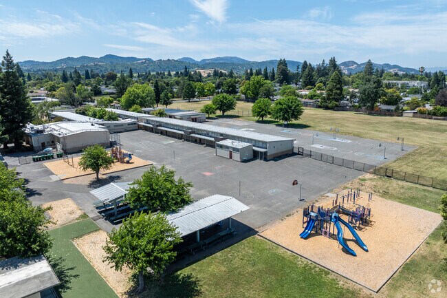 Pueblo Vista Elementary School also has a blacktop and playground structure.