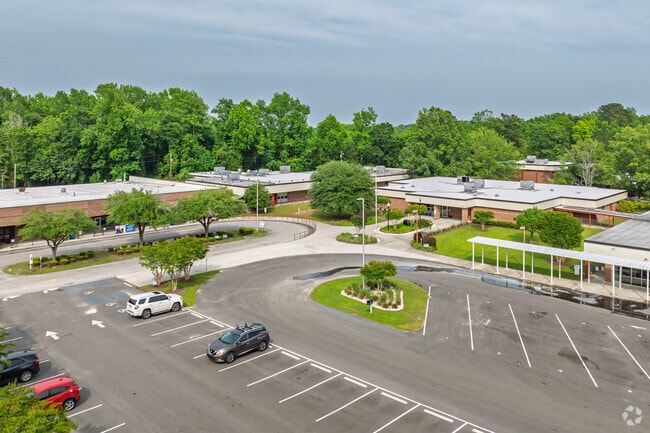 Aerial view showcases the full Bolivia Elementary School campus surrounded by greenery.