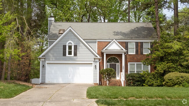 This two-story home has a single-car garage and nice landscaping in West Sugar Creek.