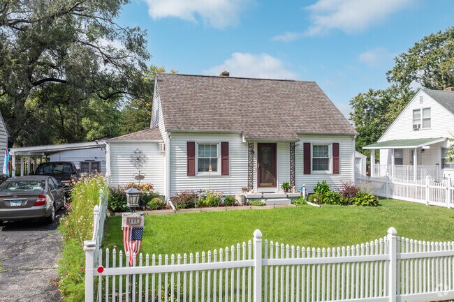 A Garden Park home maintains a tidy lawn with a white picket fence.