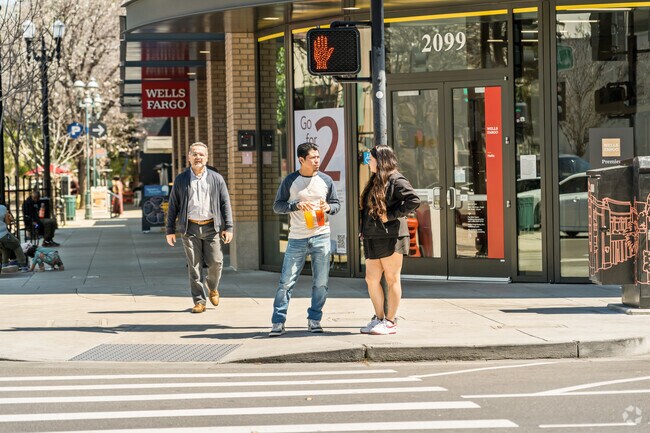 A couple shares a moment on sunny streets near Staumbaugh Heller.