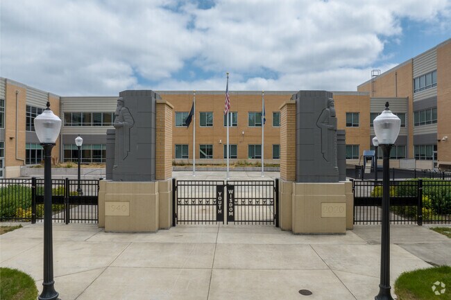 Large statues and a flag display sit along N Main Ave at Gresham High School in Gresham.