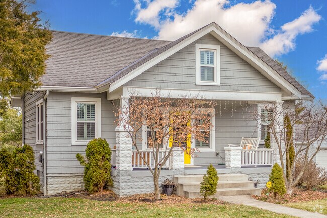 A craftsman style bungalow home with a vibrant door in Madeira.