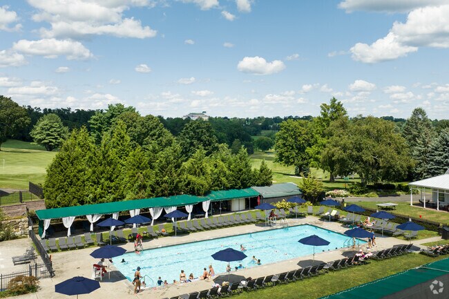 Harrison residents relax after a round at Winged Foot Golf Club with a dip in the inviting pool.
