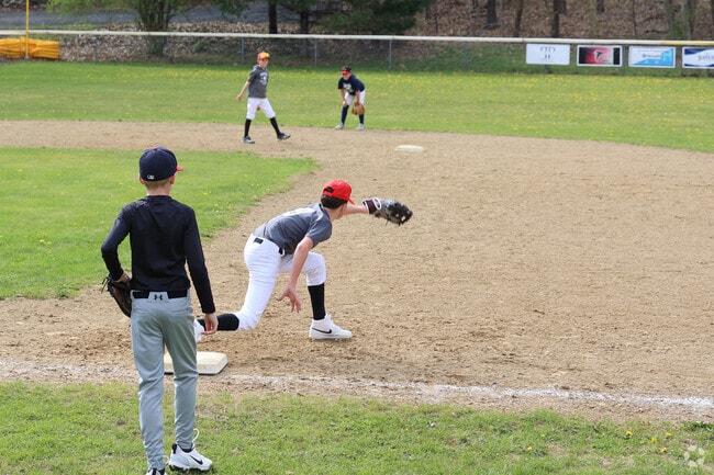 Kids in Boxford have little league practice in the field by Stiles Pond.