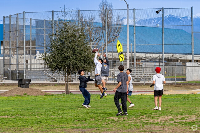 Farmersville High School teens play a game of football at the sports park.