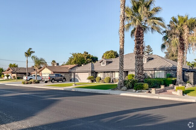 Palm trees and manicured lawns front long ranch homes in Greenfield.