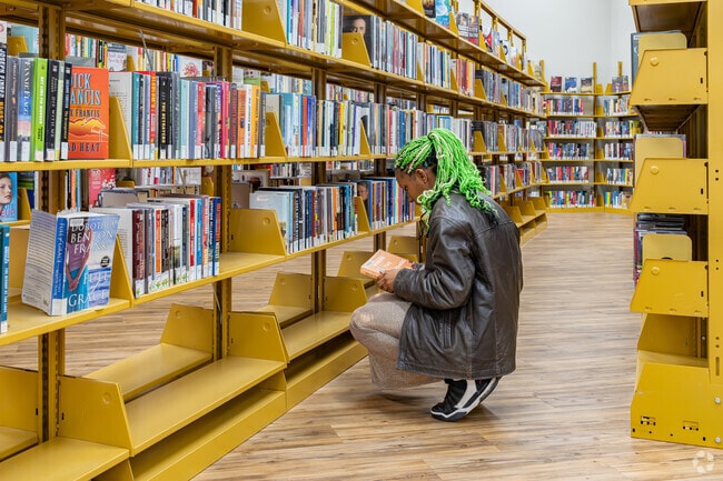 A North Country Meadows high school student selects her next read at Rathbun Branch Library.