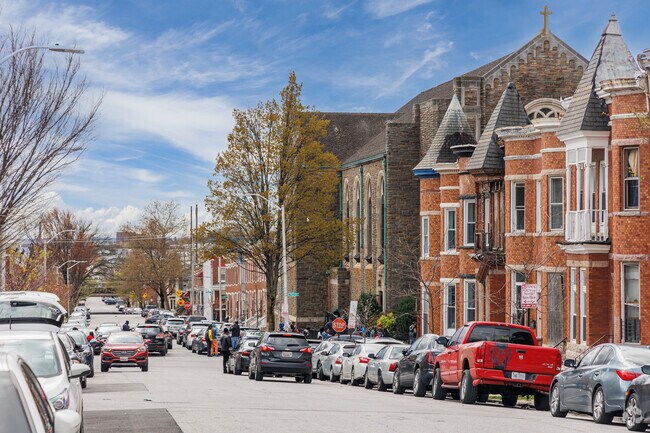 Two and Three story brick row-homes line the sidewalks of Biddle Street.