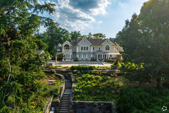 Houses tucked into the forest along the water can be found around Pines Lake.