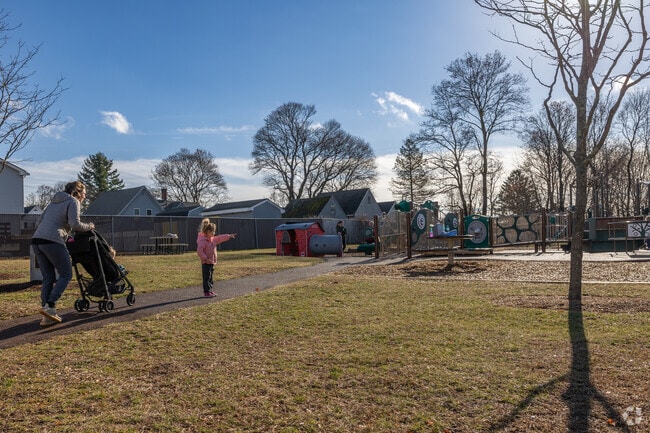 A family strolls in the busy Nason Street Playground in Downtown Franklin.