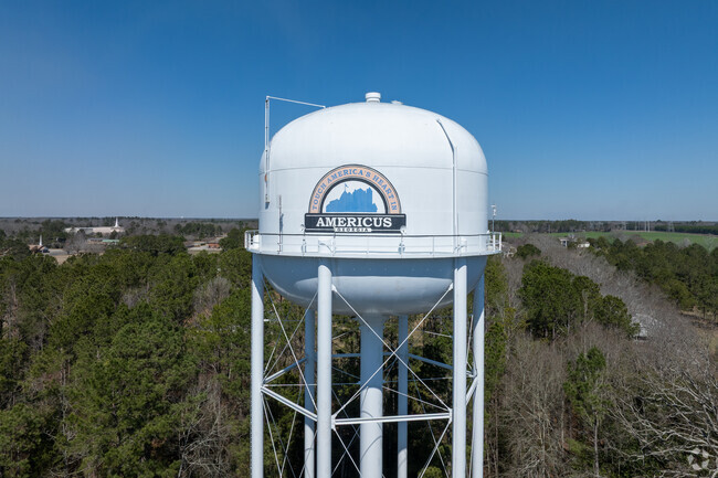The water tower prominently features the name Americus, GA.