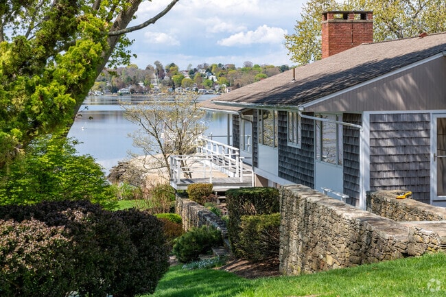 Outdoor charm blends stone and wood in Touisset Highlands landscaping.