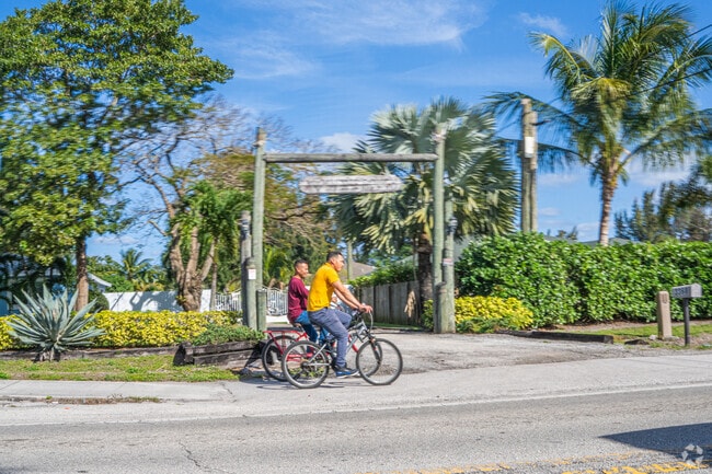 Exploring the lush streets of West Boynton on bikes, surrounded by abundant greenery.