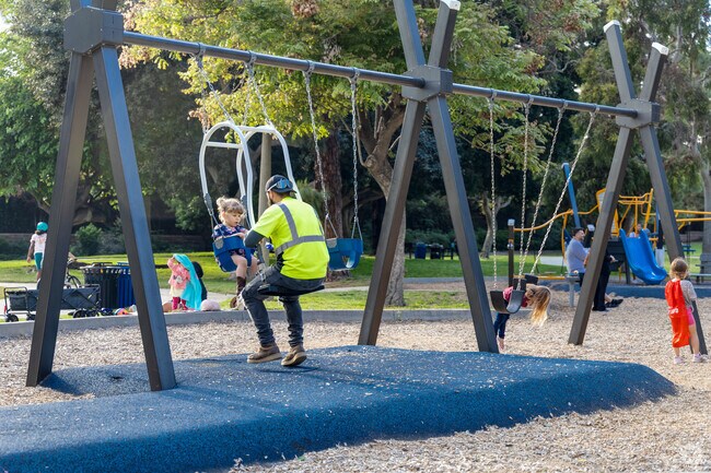 A father swings with his daughter at La Mesita Park in Fletcher Hills.